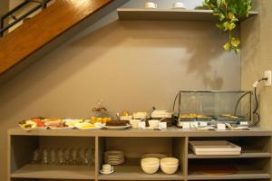 a shelf with food on it under a staircase at Pousada Clementine in Gramado