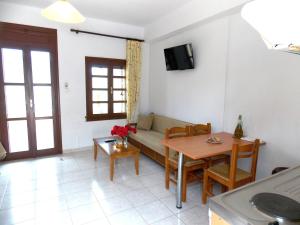 a living room with a couch and a table at Kato Zakros Palace Apartments in Kato Zakros