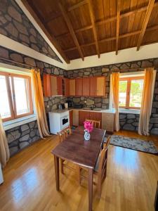 a kitchen with a table and chairs in a room at Aura Seaside Apartments in Petra