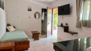 a bedroom with a bed and a tv in a room at Liokorni Village in Gaios