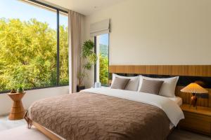 a bedroom with a large bed with a large window at 微云隐舍 in Jiazaiwei +50 photos