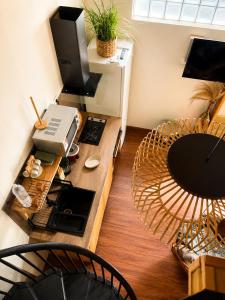 a living room with a desk with a television and a table at Lodge Sakayu - Charme, calme & piscine privée in Saint-Louis
