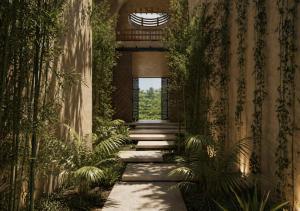 a walkway in a building with plants at Casa Joseph Troncones - Adults Only in Troncones
