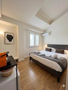 a bedroom with a large bed in a room at La Costa Rooms in Flumini di Quartu