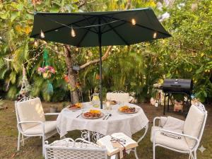 a table with plates of food and an umbrella at Tamarindo Village in San Carlos