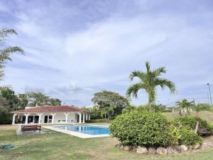a villa with a swimming pool and a house at Tamarindo Village in San Carlos +40 photos