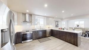 a kitchen with a refrigerator and a stove top oven at Orchard Haven in Orono