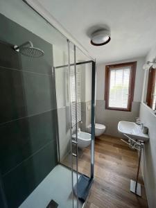 a bathroom with a glass shower and a sink at Chalet Blanc le Refuge in Courmayeur