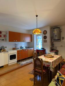 a kitchen with a table and a dining room at Residenza Dei Castelli in Coredo