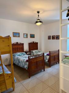 a bedroom with two beds and a ladder at Residenza Dei Castelli in Coredo +13 photos