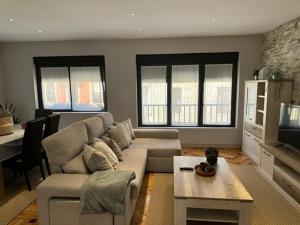 a living room with a couch and a table at Apartamentos Jayo in Nueva de Llanes