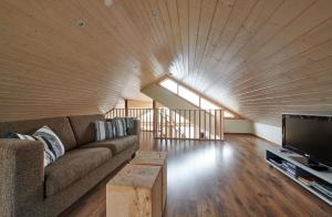 a living room with a couch and a tv at Brekka in Akranes
