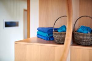 two baskets of towels on a shelf in a bathroom at Brekka in Akranes +38 photos