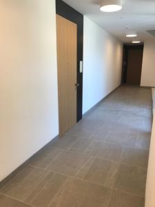 an empty hallway with a door and a tile floor at Dukley residence Lux in Budva