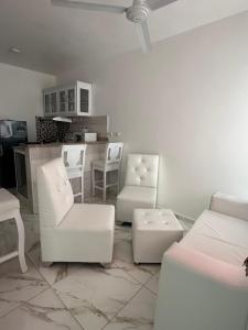 a living room with white furniture and white chairs at SahiR 2 in Cantabria