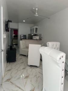 a white living room with a couch and a table at SahiR 2 in Cantabria +9 photos