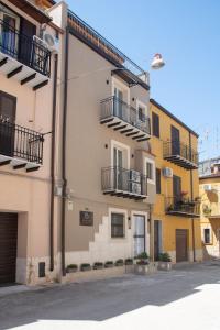 a building with balconies on the side of it at Il Vicolo al Centro in Raffadali