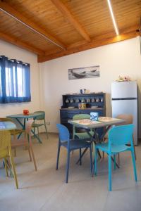 a room with tables and chairs and a refrigerator at Il Vicolo al Centro in Raffadali