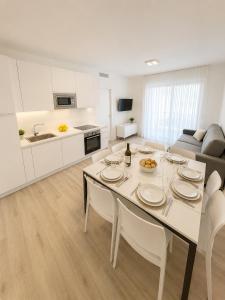 a kitchen and living room with a table and chairs at Haus Margarete - Agenzia Cocal in Caorle