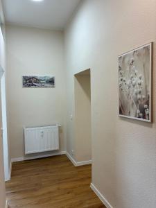 a room with a hallway with white walls and wooden floors at Gästehaus Lelo 1 in Solingen