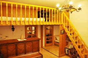 a room with a loft bed and a staircase at Traditional Slovak Apartment in Bratislava