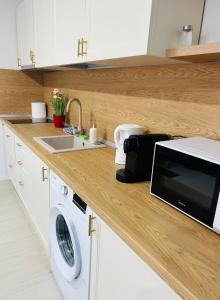 a kitchen counter with a sink and a microwave at Nicotel in Turda