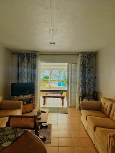 a living room with a couch and a table at 11 Residence Thalassa in Belle Mare