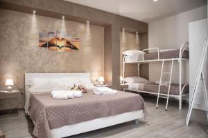 a bedroom with a bed with two bunk beds at Il Vicolo al Centro in Raffadali +45 photos