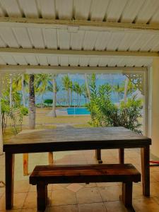 a wooden bench sitting in front of a porch at 11 Residence Thalassa in Belle Mare +2 photos