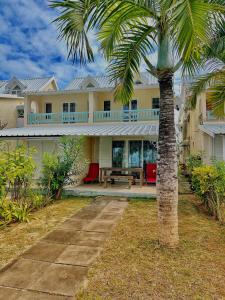 a palm tree in front of a house at 11 Residence Thalassa in Belle Mare