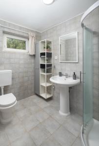 a bathroom with a toilet sink and a shower at Villa Insula by Belmont Realty in Vela Luka +70 photos
