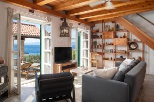 a living room with a couch and a view of the ocean at Villa Insula by Belmont Realty in Vela Luka