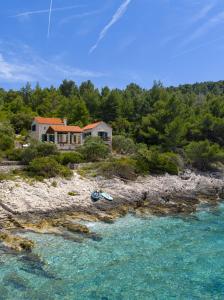 a house on an island in the water at Villa Insula by Belmont Realty in Vela Luka