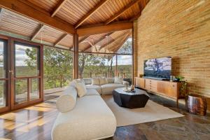 a living room with a couch and a tv at The Hills Opera House in Bickley