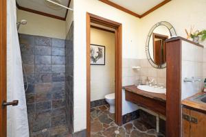 a bathroom with a sink and a toilet and a mirror at The Hills Opera House in Bickley +44 photos