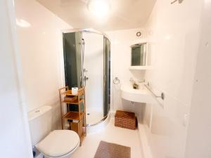 a bathroom with a shower and a toilet and a sink at Serce Puszczy in Drawsko