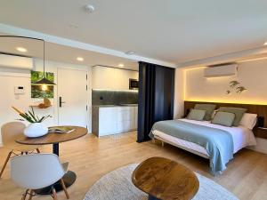 a bedroom with a bed and a table in a room at YourHouse As Escadas in Allariz