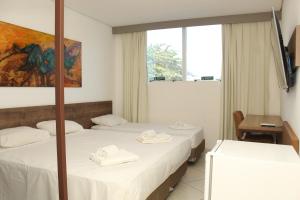 a hotel room with two beds and a window at Barretos Park Hotel in Barretos +69 photos