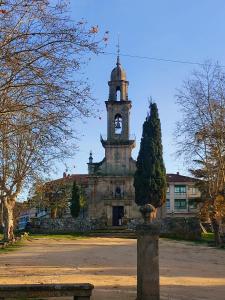 an old building with a clock tower in a park at YourHouse As Escadas in Allariz +2 photos