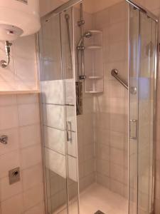 a shower with a glass door in a bathroom at Grace House in Marina di Sorso +32 photos