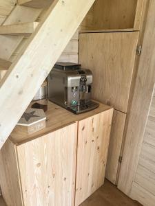 a microwave sitting on top of a wooden counter at Serce Puszczy in Drawsko +9 photos