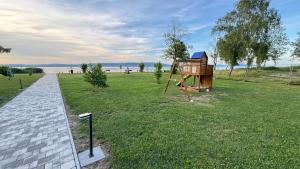 a park with a play structure in the grass at Violett Apartman in Balatonberény