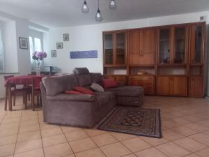a living room with a couch and a table at Da Elena e Michele in Coazze