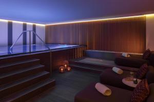 a room with a staircase with a bench and a table at Anantara Palais Hansen Vienna - A Leading Hotel of the World in Vienna