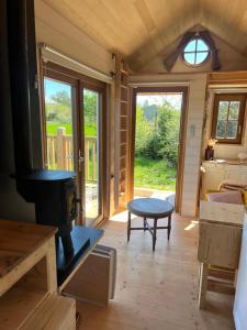 a room with a woodburning stove in a tiny house at Tiny House chez Annette in Darvoy