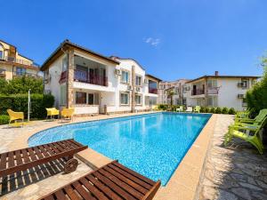 a swimming pool in front of a house at Complex Sea & Sky next to the Beach ! in Kranevo