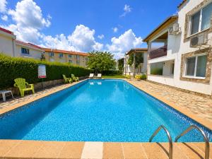 a swimming pool in the backyard of a house at Complex Sea & Sky next to the Beach ! in Kranevo