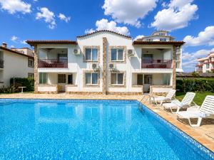 a villa with a swimming pool and a house at Complex Sea & Sky next to the Beach ! in Kranevo
