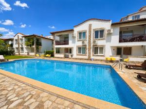 a swimming pool in front of a house at Complex Sea & Sky next to the Beach ! in Kranevo