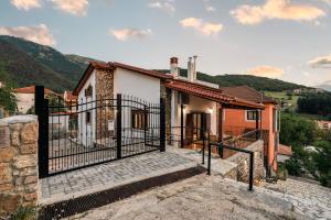 a house with a gate in front of it at Epi tis Stigos in Kalavrita